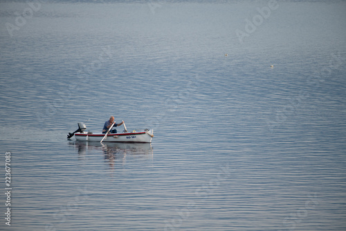 Old traditional fisherman in Croatia on a small wooden boat back into the harbor early morning © asafaric
