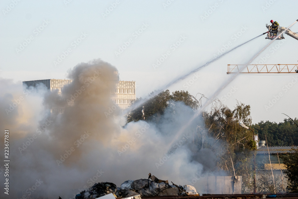 Fototapeta premium firefighters during the action of extinguishing a powerful fire of a recycling company.Poland, Szczecin