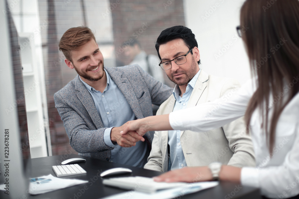 businessman and business woman handshake over the Desk businessman and business woman handshake over the Desk