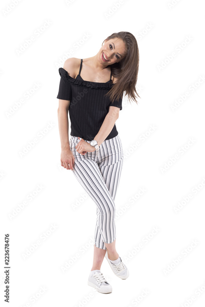 Fototapeta premium Cute affectionate youthful woman smiling with cocked head and looking at camera. Full body isolated on white background. 