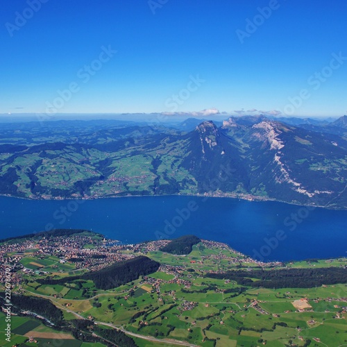 Azure blue Lake Thun. Sigriswiler Rothorn and Niederhorn, mountains in the Bernese Oberland, Switzerland. Village Spiez. photo