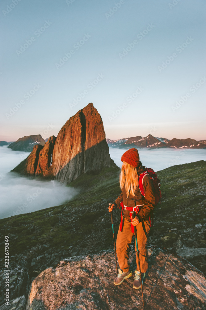 Woman traveler hiking outdoor in Norway active vacations traveling adventure lifestyle girl with backpack enjoying sunset Segla mountain