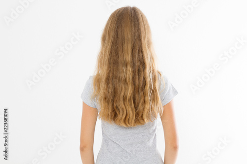 Blonde girl with long and wavy healthy hair isolated on white background. Young woman fashion hairstyle back view. Template and blank copy space.