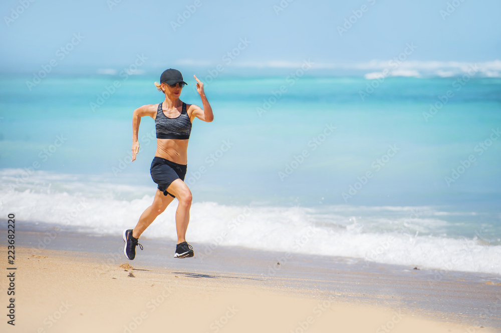 young happy and attractive sport runner woman doing running workout sprinting on tropical paradise beach showing fit and athletic body in wellness fitness concept young happy and attractive sport runner woman doing running workout sprinting on tropical paradise beach showing fit and athletic body in wellness fitness concept
