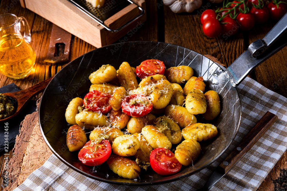 gnocchi baked with green pesto, cherry tomatoes and parmesan gnocchi baked with green pesto, cherry tomatoes and parmesan