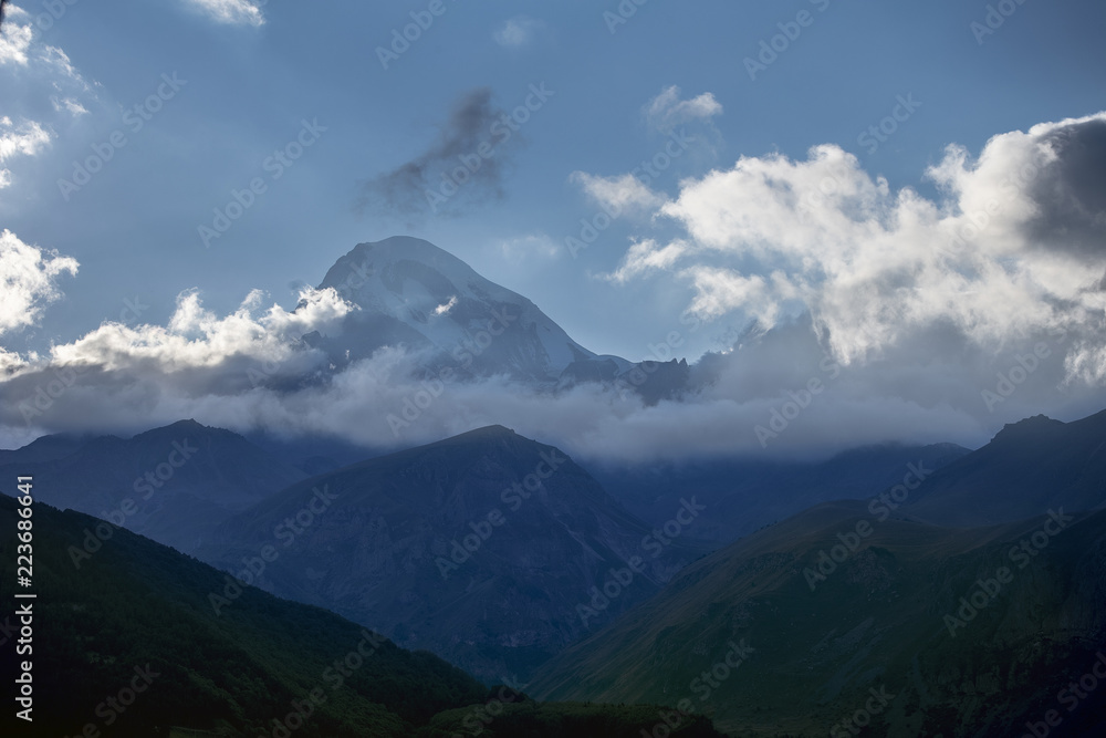 Panorama of the Mountain at dawn, the tents of tourists are on the hill, Georgia, Kazbek Panorama of the Mountain at dawn, the tents of tourists are on the hill, Georgia, Kazbek