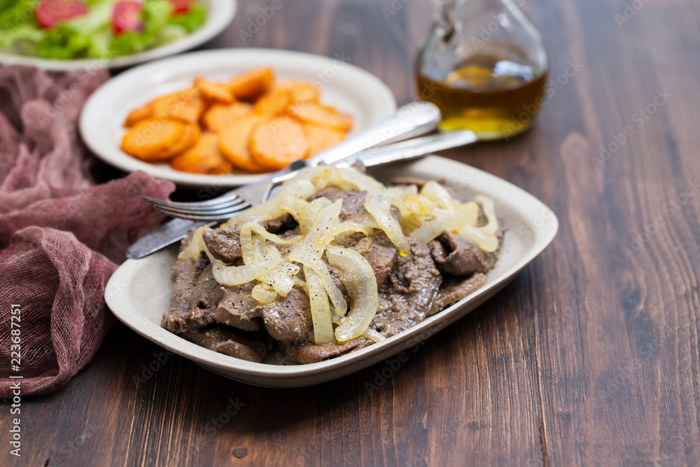 fried liver on white dish and fried sweet potato on plate fried liver on white dish and fried sweet potato on plate