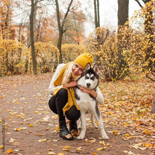 Girl and dog husky outdoors