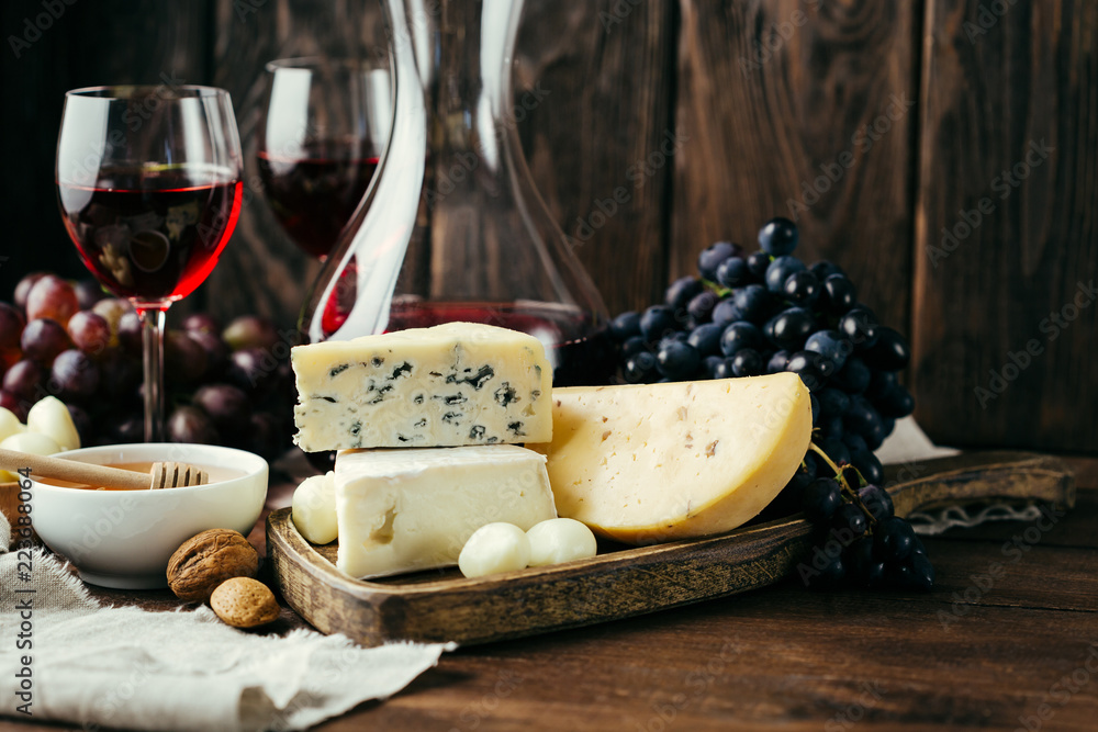 Cheese and wine, Decanter and glasses, wooden background, appetizer, grapes Cheese and wine, Decanter and glasses, wooden background, appetizer, grapes