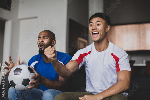 Male friends watching a football match