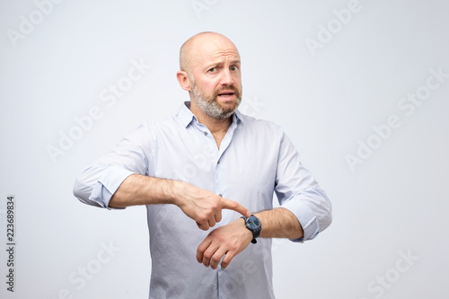 Принти на полотні Mature european businessman impatiently pointing to his watch
