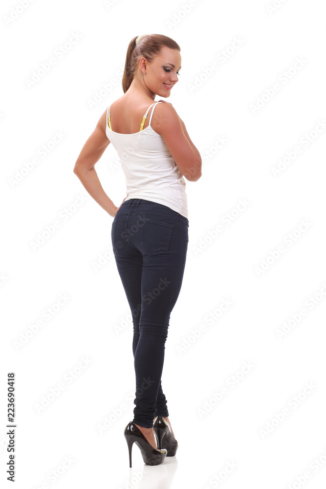 Full length portrait woman in a white tank top and jeans. Full length portrait woman in a white tank top and jeans.