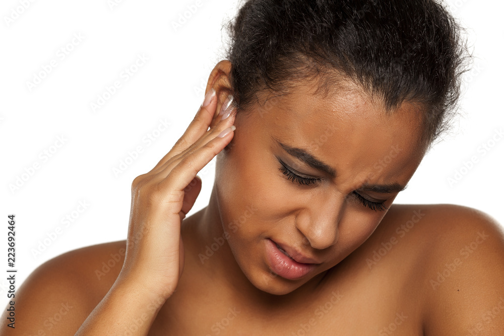 portrait of young dark-skinned woman with pain in her ear on white background portrait of young dark-skinned woman with pain in her ear on white background