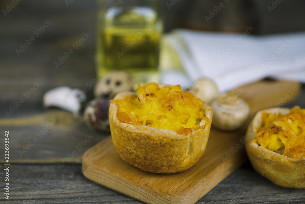 Baked puff pastry with potato filling and cheese on a wooden board Baked puff pastry with potato filling and cheese on a wooden board