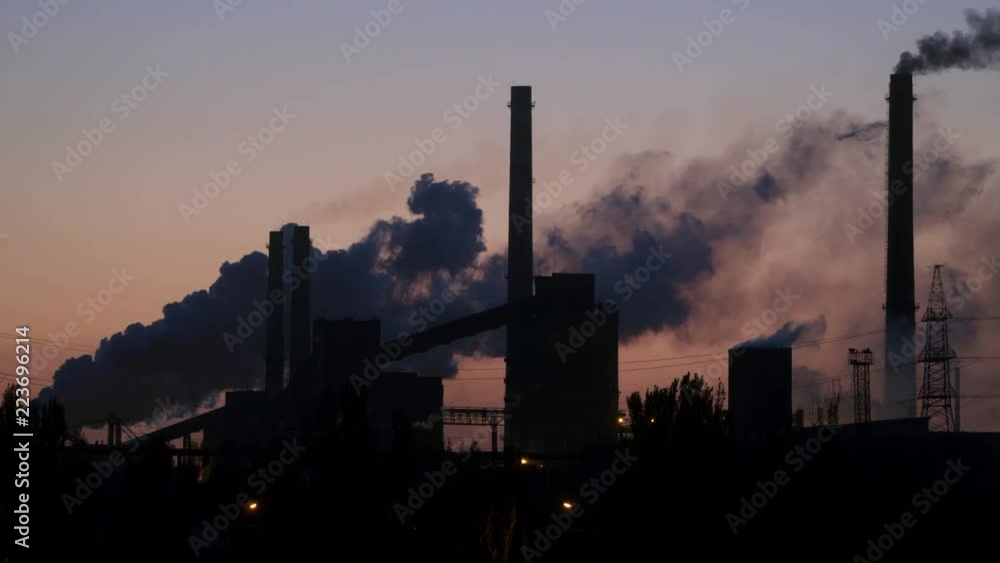Pipes and smoke of the metallurgical plant against the background of the pre-dawn sky. Pipes and smoke of the metallurgical plant against the background of the pre-dawn sky.