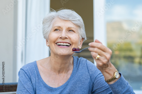 Senior woman eating fruit