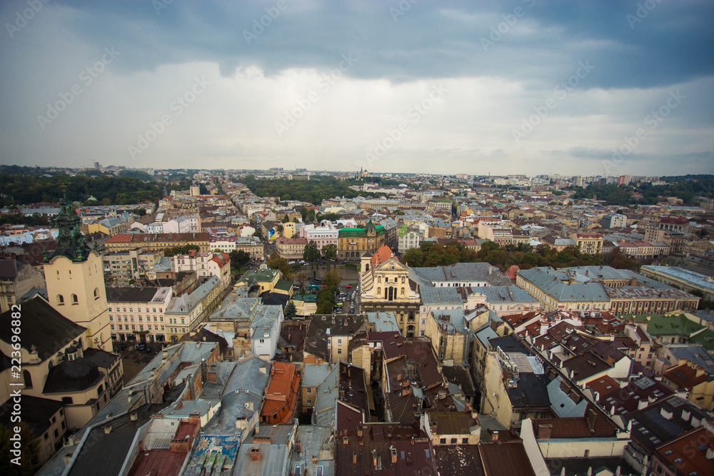 Aerial view old european city with rainy clouds on background
