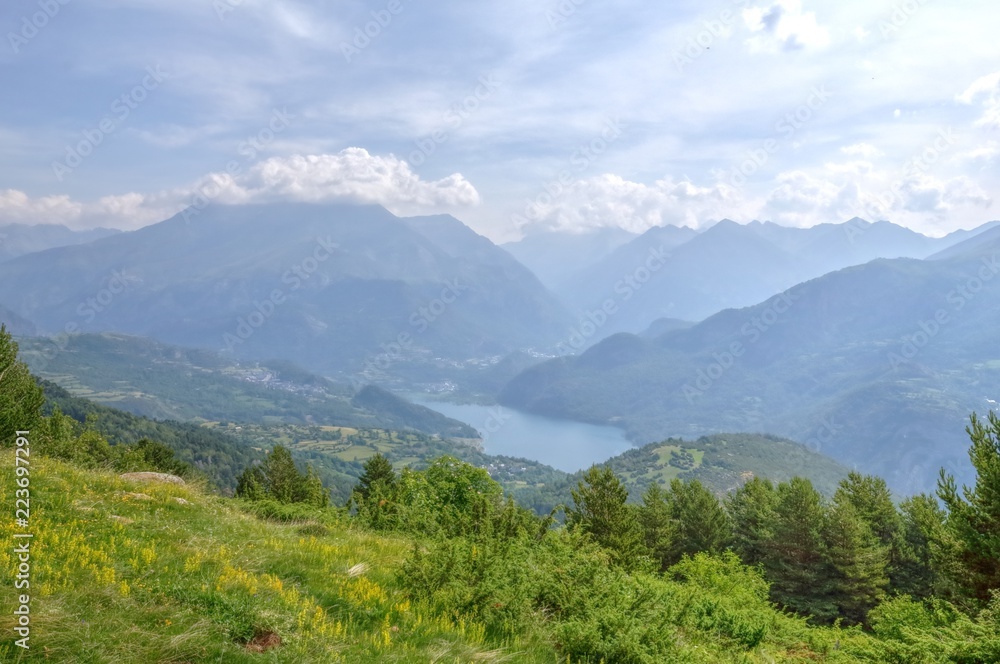 A Bubal lake landscape seen from the path to the Piedrafita de Jaca lake in the Aragonese Pyrenees in a cloudy and sunny day