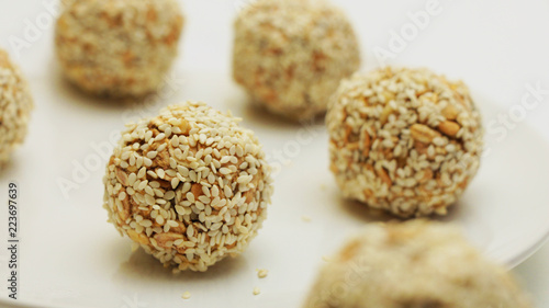 Healthy Energy Granola Bites covered with Sesame Seeds. Vegan, Vegetarian Raw Snack or Meal