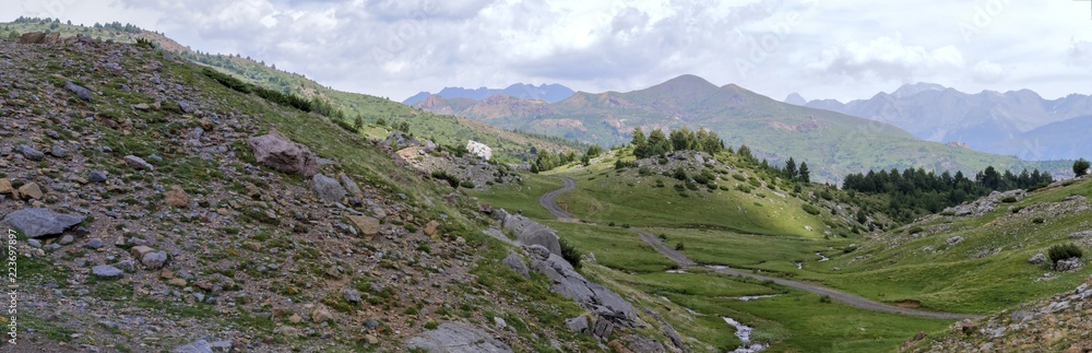 The mountains and the massif along the green path to the Piedrafita de Jaca lake in the aragonese Pyrenees mountains