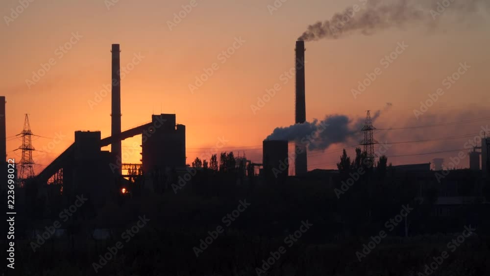 An industrial enterprise at dawn. Environmental pollution An industrial enterprise at dawn. Environmental pollution
