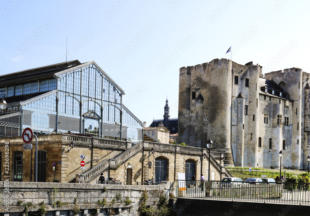 View of the Donjon and the building of the market. Niort is town in western France.