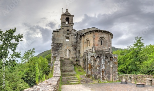 The ancient, stone-made, lost Caaveiro Monastery (Monasterio de Caaveiro) in the Fragas del Eume green and thick forest in Galicia, Spain photo