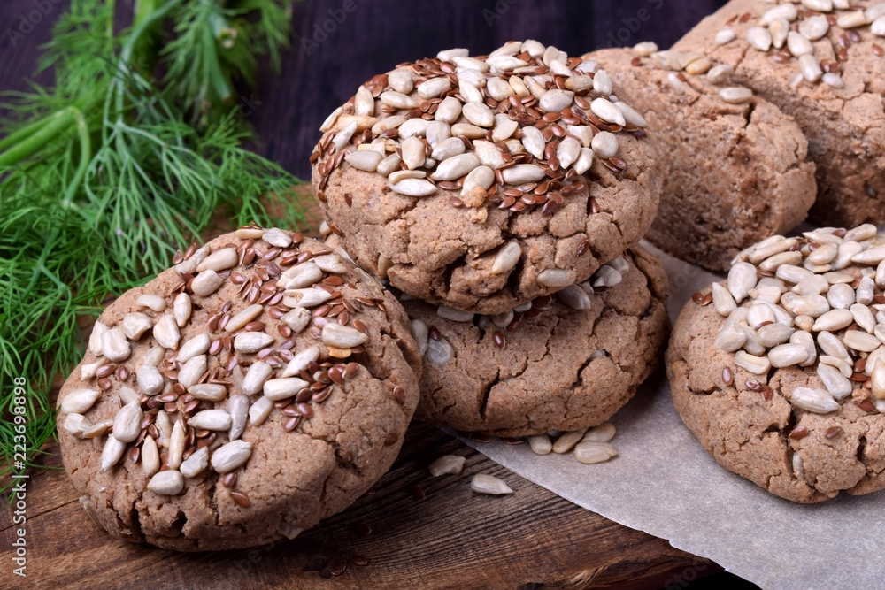 Wholegrain gluten-free buckwheat bread with sunflower and flax seeds on a wooden board Wholegrain gluten-free buckwheat bread with sunflower and flax seeds on a wooden board