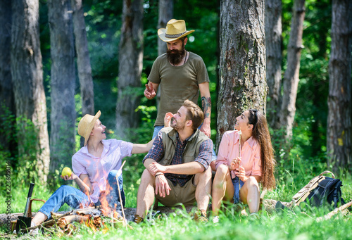 Plan for perfect day hike picnic. Company friends relaxing picnic in forest. Friends relaxing near bonfire. Friends enjoy vacation in nature forest background. Pleasant hike picnic in forest