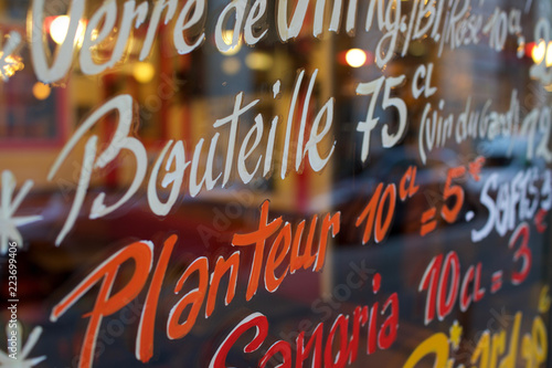 Colourful sign advertising drink sizes in cl and prices in bar, café, traditional brasserie, window - Paris, France photo