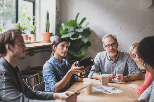 Coworkers discussing VR headset technology photo