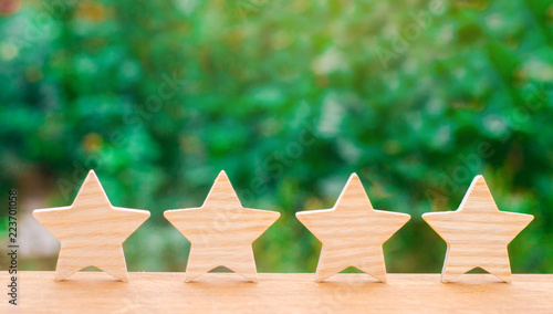 Four wooden stars. The concept of rating and evaluation. The rating of the hotel, restaurant, mobile application. Quality service, buyer choice. Success in business