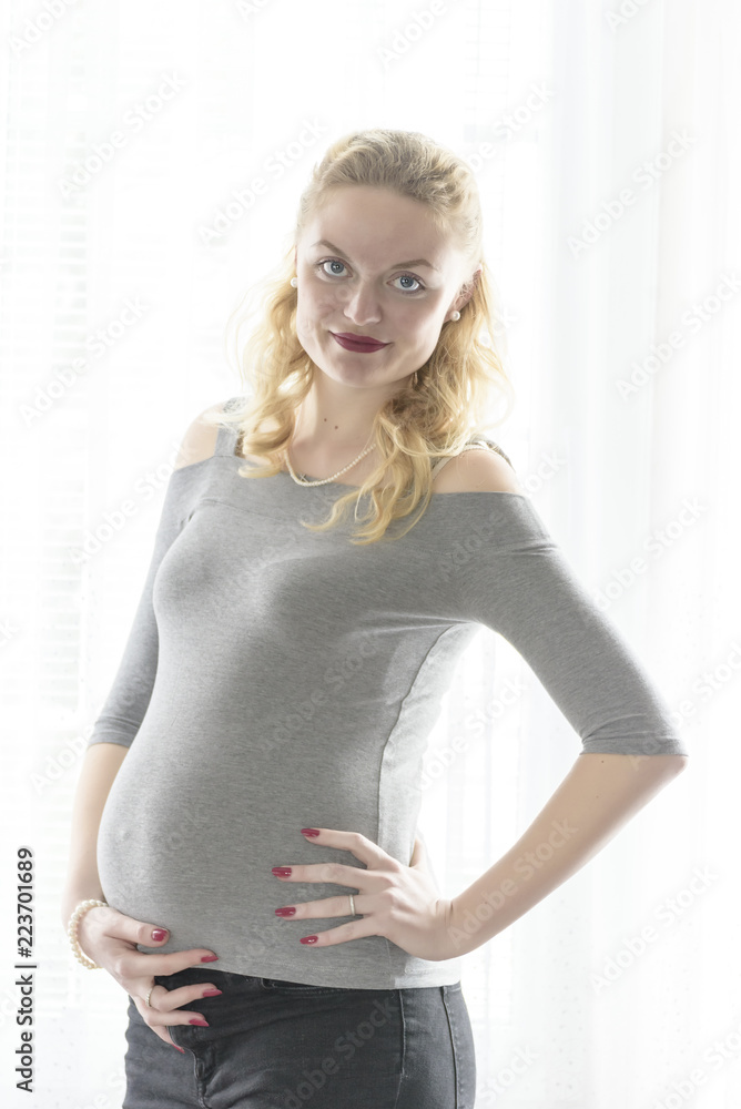 portrait of a pregnant woman with hands on her belly portrait of a pregnant woman with hands on her belly
