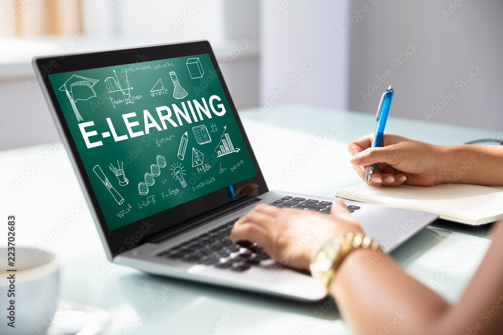 Businesswoman Using Laptop With E-learning Concept On Screen Businesswoman Using Laptop With E-learning Concept On Screen