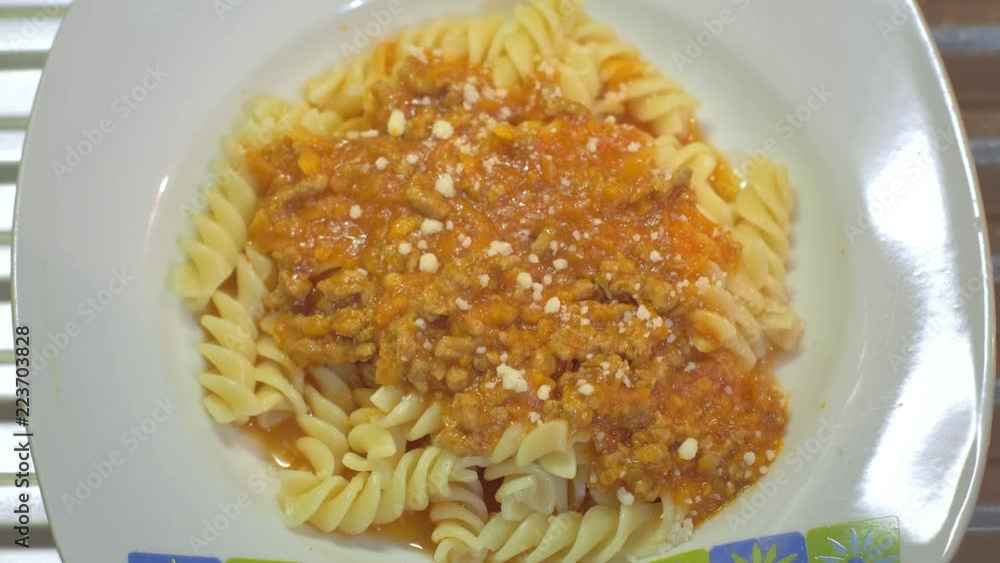 Grating cheese on pasta bolognese meal. Grating cheese on pasta bolognese meal.