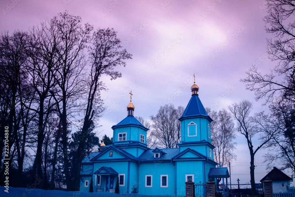 The old blue Ukrainian church against the background of a blurred sky