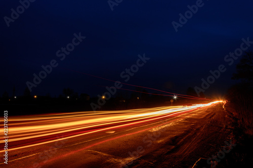 Headlights of cars, taken with long-term exposure to the background of the sky