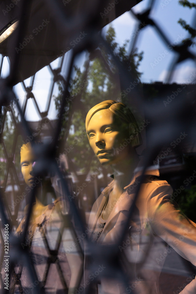 Mannequins behind a security fence. Mannequins behind a security fence.