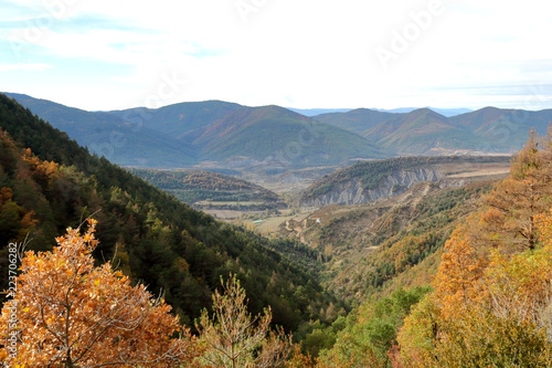 Blue cloudy sky and typical mountains and hills covered with forest met in autumn while hiking from the small Yebra de Basa town to Santa Orosia church on the Pyrenees mountains  Aragon  Spain