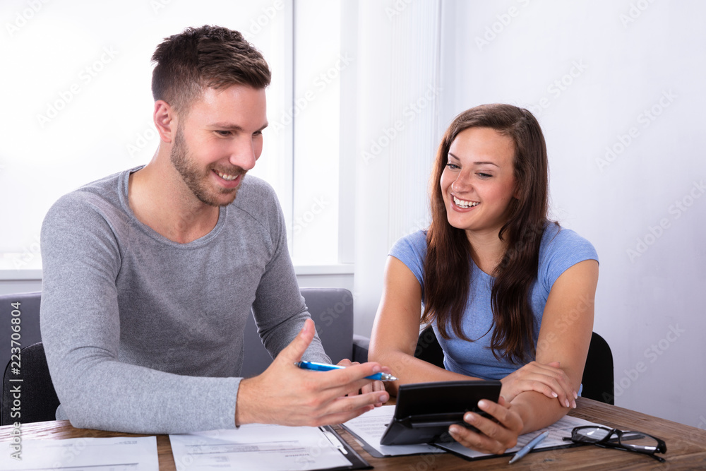 Happy Couple Calculating Bill Happy Couple Calculating Bill