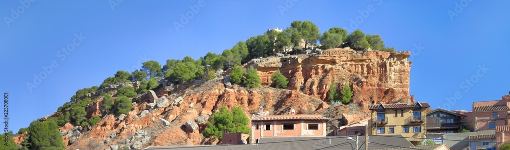 A sight of the Anento Castle on top of a rocky red mountain