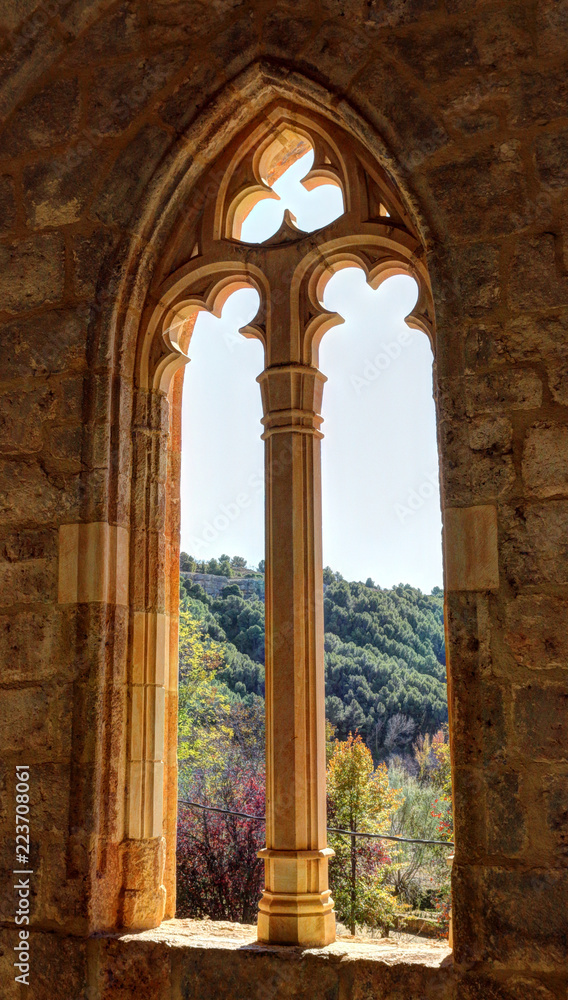 The Gothic pointed arch window with decorations at the entrance of the Saint Blaise church (Iglesia de San Blas) in the Anento small town, in Aragon province, Spain