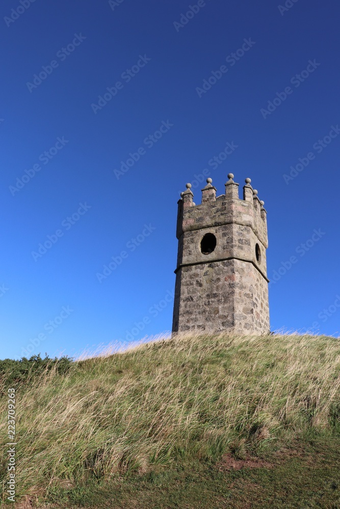 Old dovecot on hill against blue sky Old dovecot on hill against blue sky