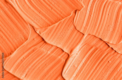 Orange facial mask (pumpkin cream, body scrub) texture close up. Abstract background with brush strokes.