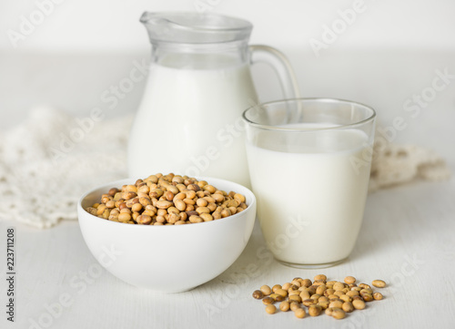 Soy milk and soybeans on a white table