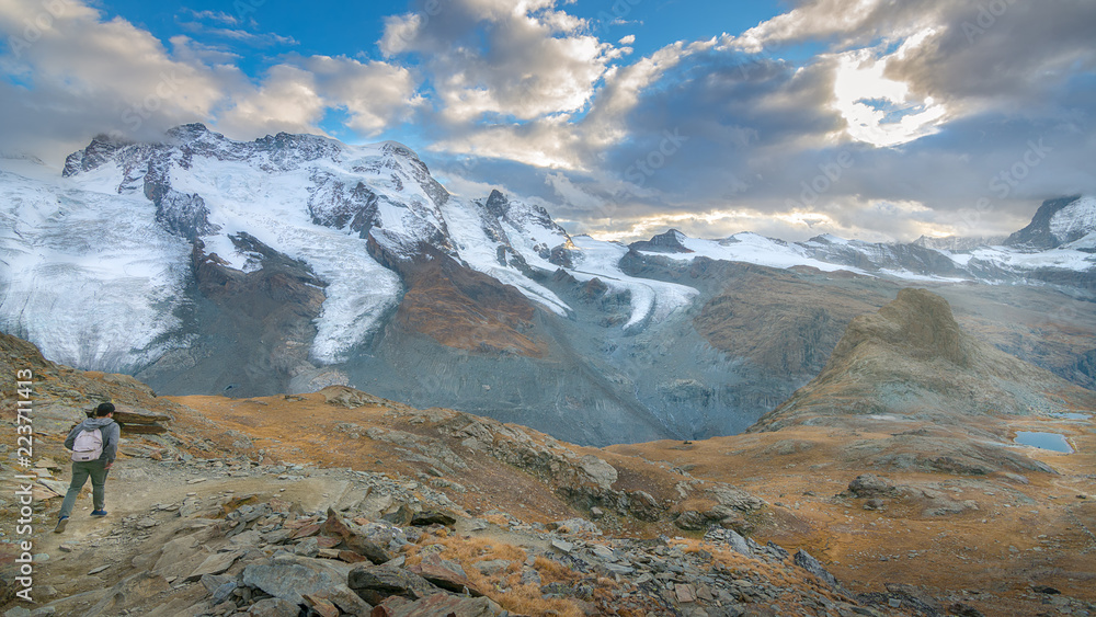 Hiker enjoying the amazing glacier view with Zermatt peak at background, Switzerland