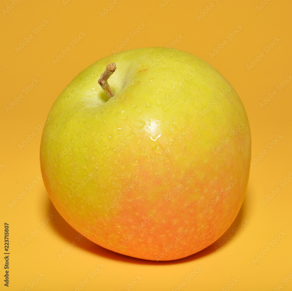 Ripe Apple with red side isolated on yellow background Ripe Apple with red side isolated on yellow background