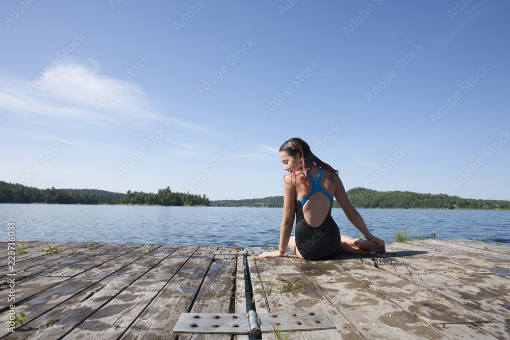 Preteen teens playing and jumping off a dock. Preteen teens playing and jumping off a dock.