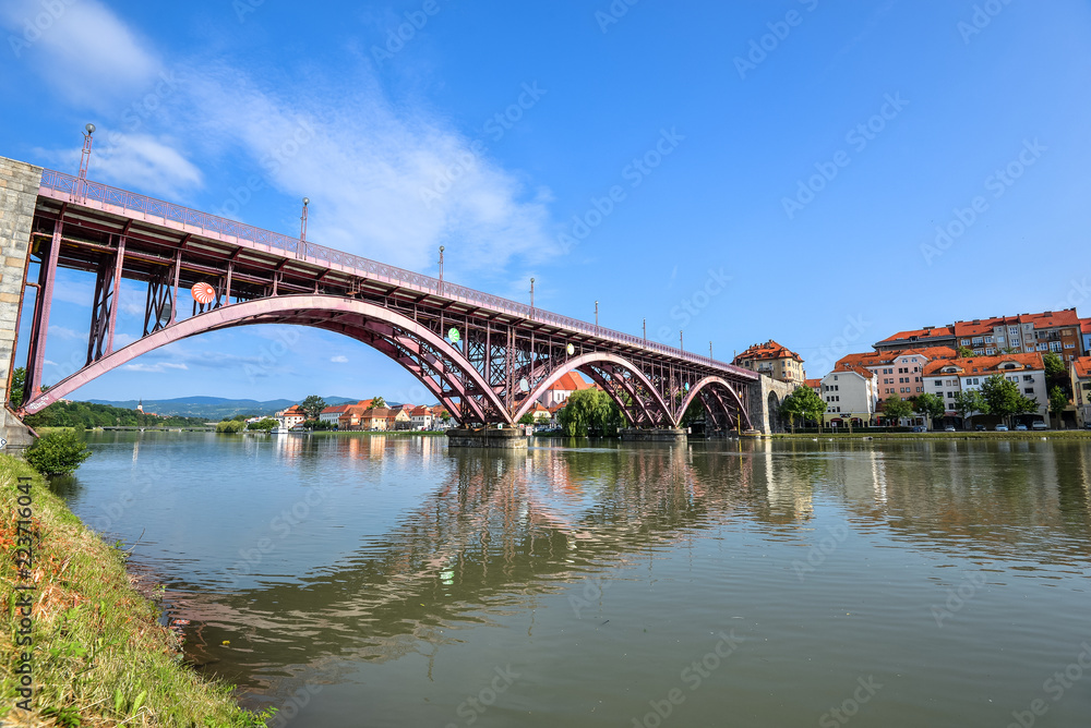 Drava river, sky reflection and bridge. The Main Bridge across Drava river in Maribor, Slovenia