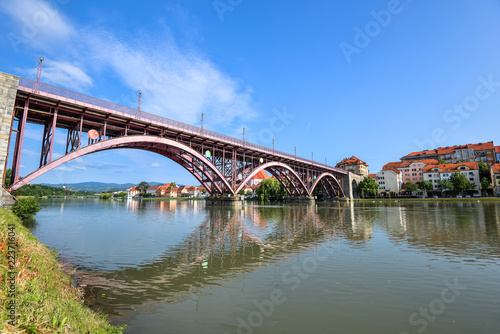 Drava river, sky reflection and bridge. The Main Bridge across Drava river in Maribor, Slovenia